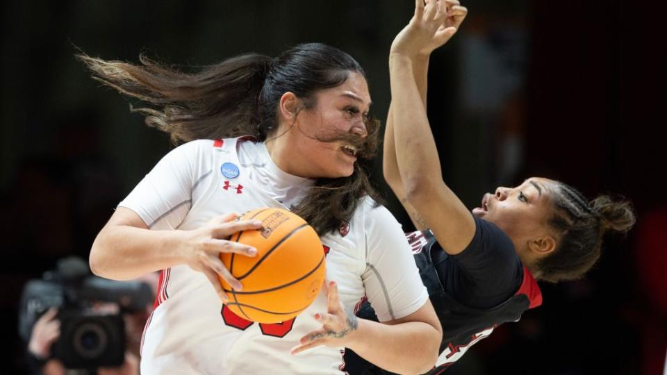 Alissa Pili #35 of the Utah Utes knocks over Alasia Smith #30 of the Gardner-Webb Bulldogs as she drives to the basket during the first half of the first round of the NCAA Womens Basketball Tournament.