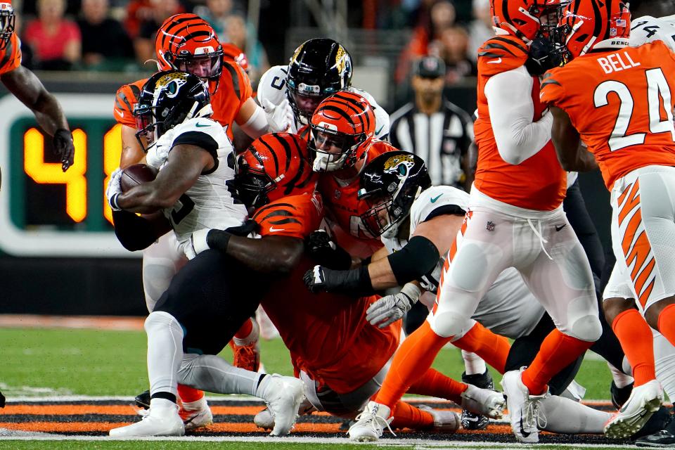 Cincinnati Bengals defensive tackle D.J. Reader (98) tackled Jacksonville Jaguars running back James Robinson (25) Sept. 30.