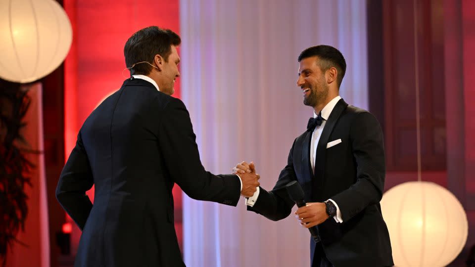 Djokovic accepts the award on stage from NFL legend Tom Brady. - Borja B. Hojas/Getty Images