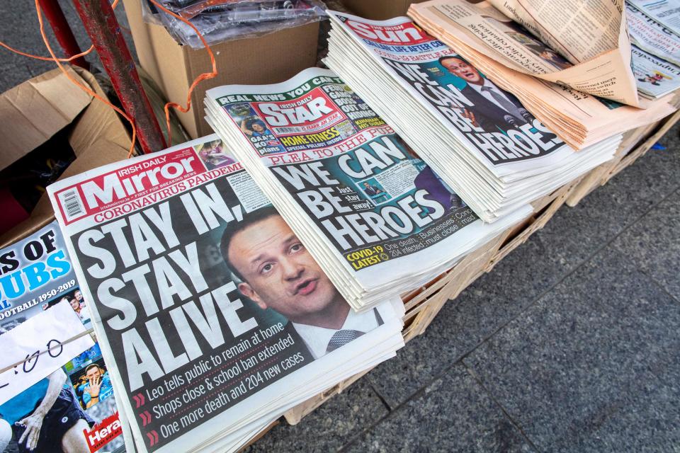 The front pages of Irish national newspapers, featuring a story about new measures introduced by Ireland's Prime Minister Leo Varadkar to help stem the Covid-19 pandemic, are pictured in a store in Dublin.