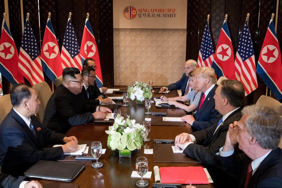 <p>President Donald Trump (3rd R) and North Korea’s leader Kim Jong Un (2nd L) sit down with their respective delegations for the US-North Korea summit, at the Capella Hotel on Sentosa island in Singapore on June 12, 2018. (Photo: Saul Loeb/AFP/Getty Images) </p>