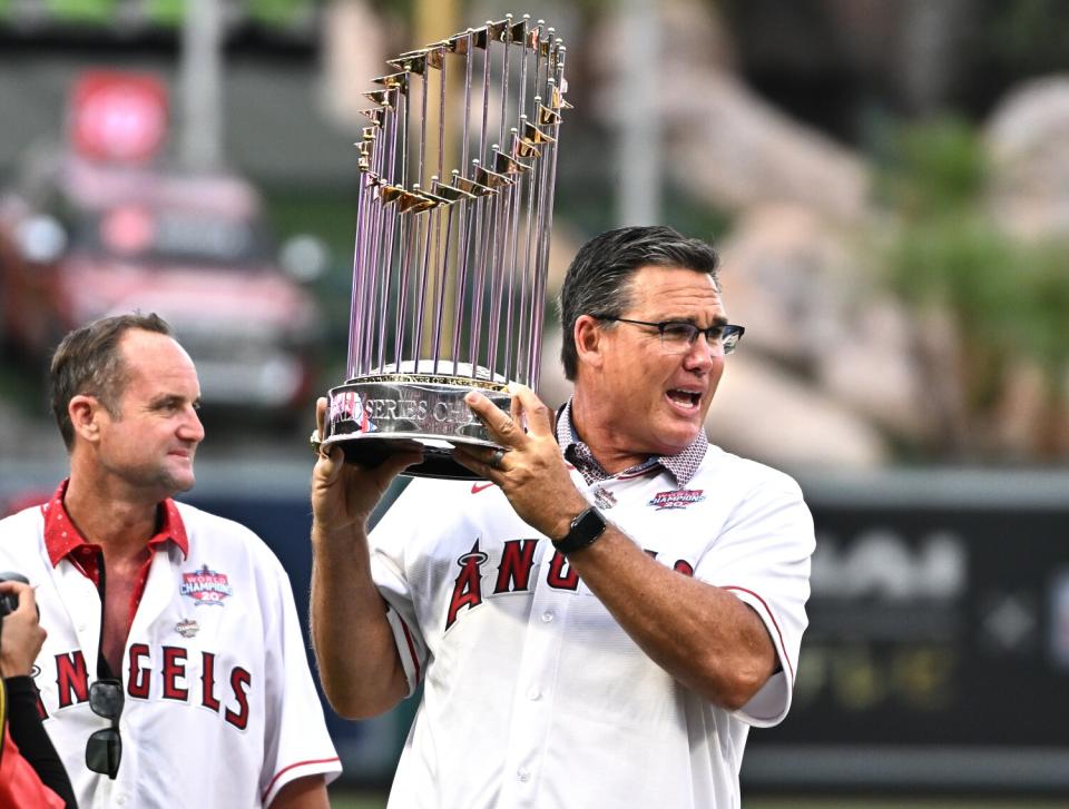 Former Angel Tim Salmon holds the championship trophy during the 20th anniversary celebration.
