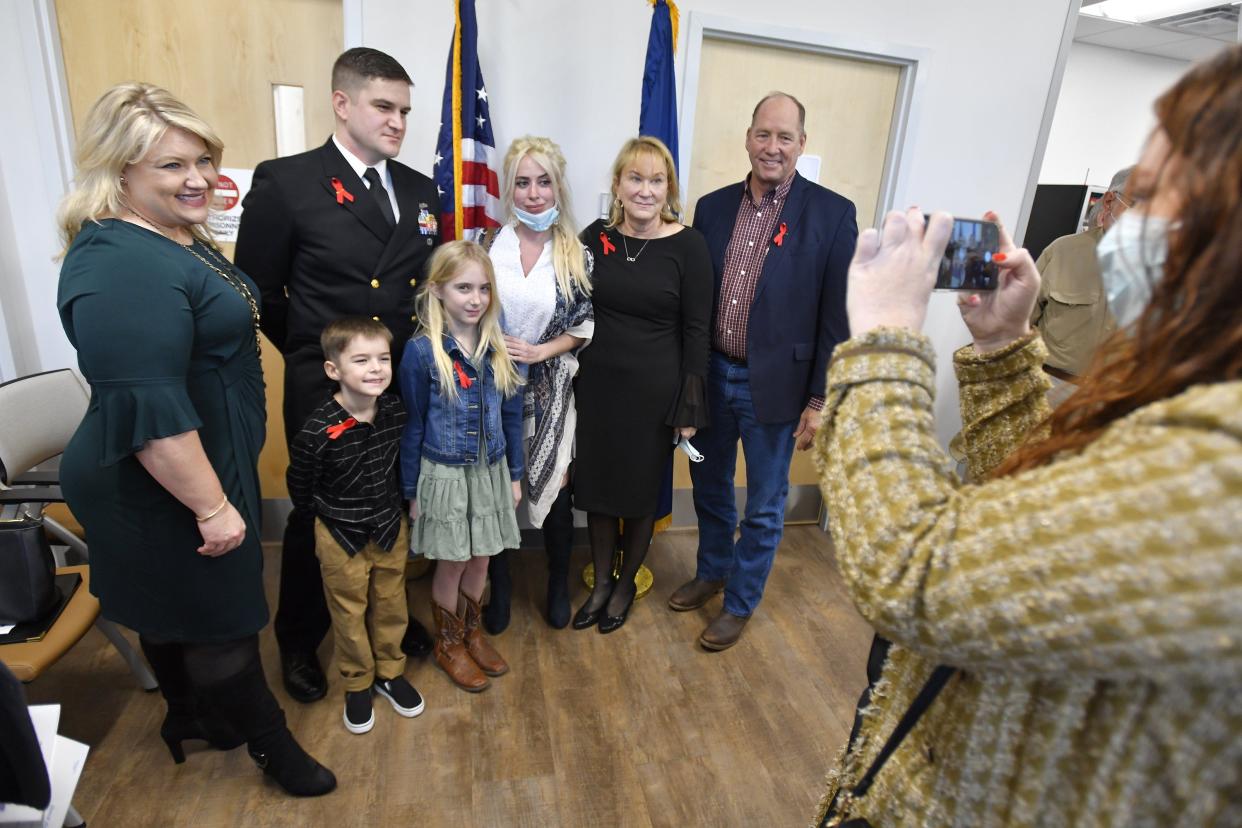 U.S. Rep. Kat Cammack (left) and her predecessor, Ted Yoho, flank Chief Petty Officer Andrew "Drew" Baker, his children Alice, 10, and Andrew Kenneth Baker III, his wife Navy Hospital Corpsman Deanna Baker and his mother Tina Baker. They attended a Tuesday ceremony renaming the Middleburg VA clinic after the late Baker patriarch, Chief Petty Officer Andrew K. Baker, who died in a Navy helicopter crash in 1997.