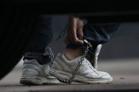 Undocumented immigrants in shackles arrive at a U.S. federal court for hearings in McAllen, Texas, U.S., June 22, 2018. REUTERS/Loren Elliott