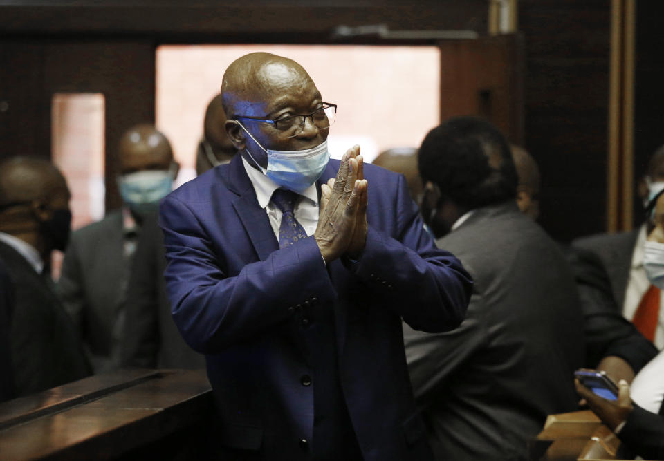 Former South African President Jacob Zuma, greets supporters on his arrival in the High Court in Pietermaritburg, South Africa, Monday, May 17, 2021. Zuma and French arms company Thales face corruption, racketeering and money laundering charges linked to an arms deal. (AP Photo/Rogan Ward/Pool)