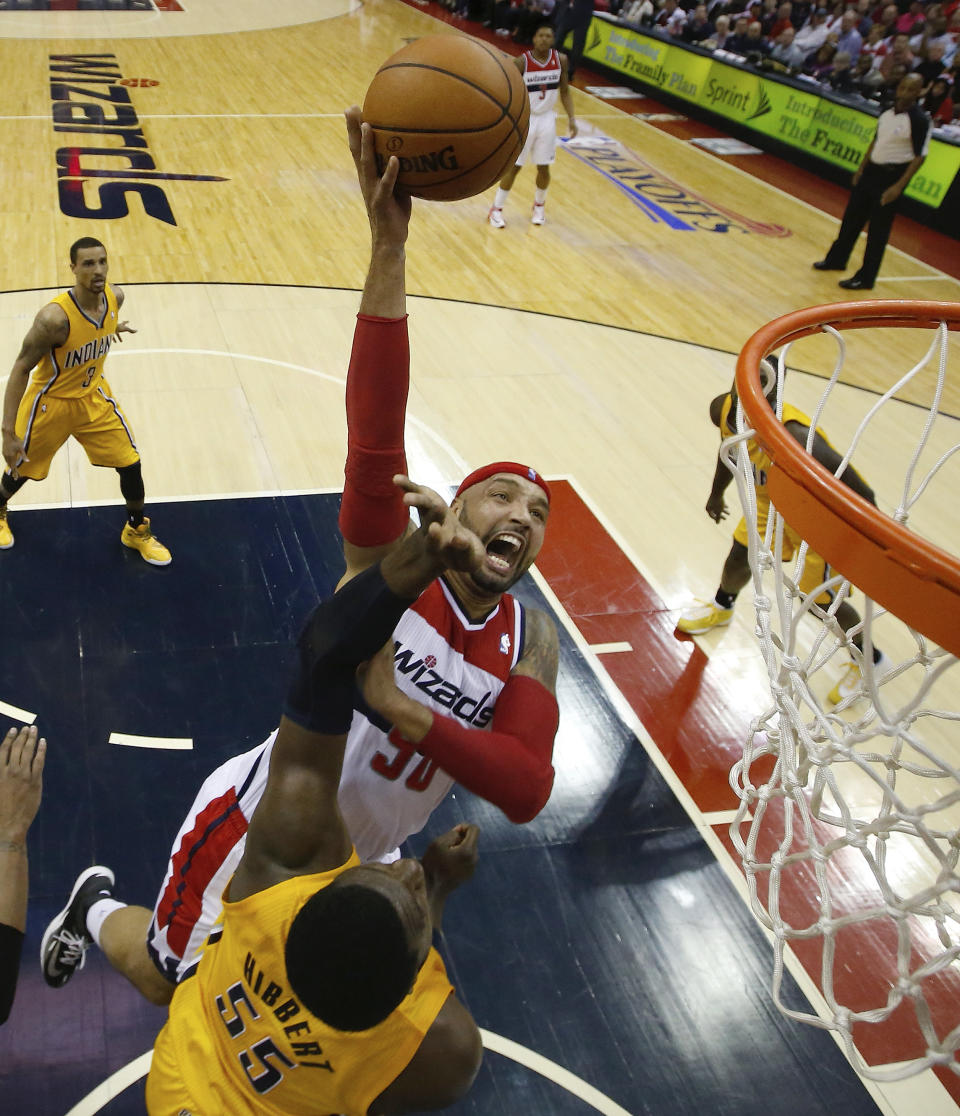 Washington Wizards forward Drew Gooden (90) shoots over Indiana Pacers center Roy Hibbert (55) during the first half of Game 4 of an Eastern Conference semifinal NBA basketball playoff game in Washington, Sunday, May 11, 2014. (AP Photo/Alex Brandon)