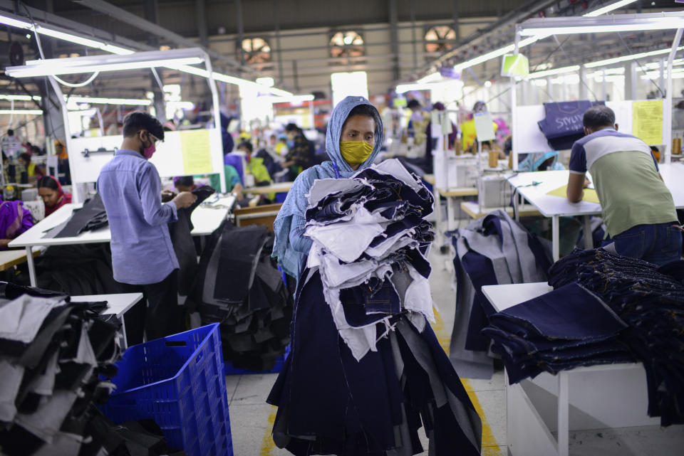 Garment factory employees work at Arrival Fashion Ltd. in Gazipur, Bangladesh, Saturday, March 13, 2021. On the eve of a half-century of independence this week, Bangladesh has been hailed as a success story for a young nation born out of strife and turbulence. Although it has struggled with famine, poverty, military coups and political violence, it's also been celebrated for what experts say is remarkable progress in uplifting the lives of its young population. Millions have risen out of poverty as the country has unexpectedly become one of Asia’s fastest-growing economies thanks to sectors like its garment industry, which clothes millions around the world. (AP Photo/Mahmud Hossain Opu)