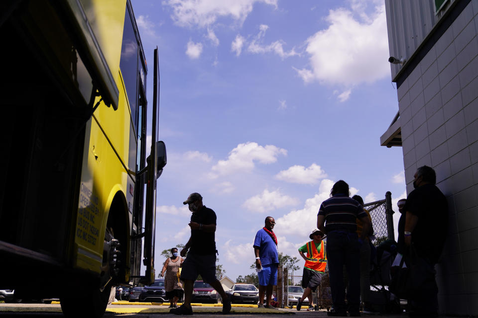 People board buses at a shelter in the aftermath of Hurricane Ida, Friday, Sept. 3, 2021, in Jefferson Parish, La. (AP Photo/Matt Slocum)