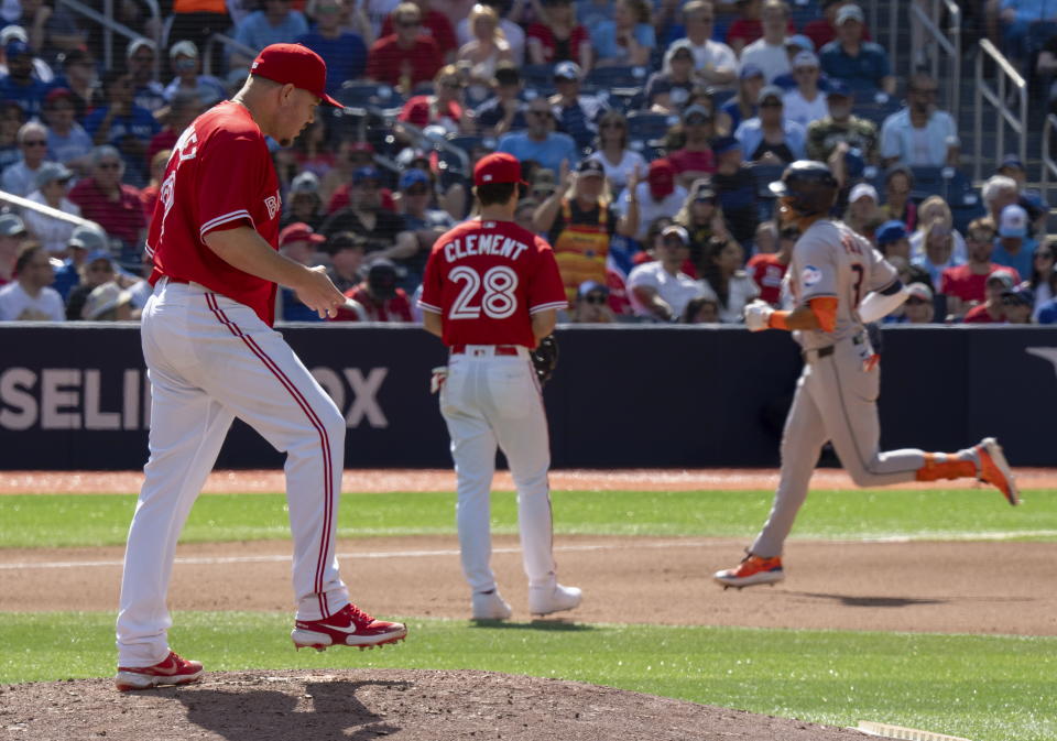 Toronto Blue Jays starting pitcher Yariel Rodriguez, left, and third baseman Ernie Clement (28) watch as Houston Astros' Jeremy Peña, rright, rounds the bases after hitting a solo home run in fifth-inning baseball game action in Toronto, Monday, July 1, 2024. (Frank Gunn/The Canadian Press via AP)