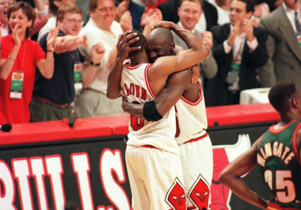 Chicago Bulls star Michael Jordan hugs Randy Brown after beating the Seattle Supersonics in Game 6 of the 1996 NBA Finals on June 16, 1996, in Chicago. The win marked their fourth NBA title. (AP/Michael Conroy)