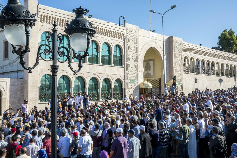 People chant slogans for ousted former Egyptian President Mohammed Morsi in Tunis, Tunisia. Tuesday, June 18, 2019. The former president, who was ousted by current President Abdel-Fattah el-Sissi in a military coup in 2013, collapsed in a courtroom in Egypt during trial on Monday and died. (AP Photo/Hassene Dridi)