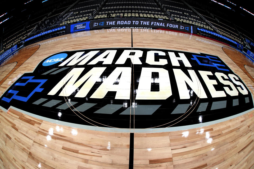 This is the NCAA March Madness logo at center court before a practice day for NCAA college men's basketball teams participating in the first and second round tournament games at PPG Paints Arena in Pittsburgh, Wednesday, March 20, 2024. First round games will be played Thursday, and second round games will be played Saturday. (AP Photo/Gene J. Puskar)