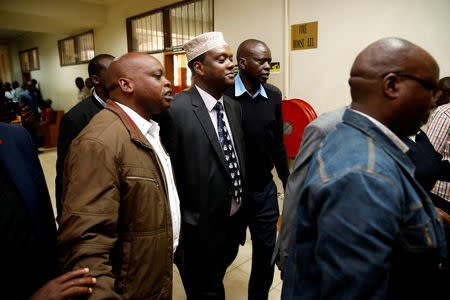 Hassan Wario, Kenya's ambassador to Austria and former sports minister is escorted by police after a hearing at the Mililani Law Court where he was charged with abuse of office and failure to comply with the law in Nairobi, Kenya, October 19, 2018. REUTERS/Baz Ratner