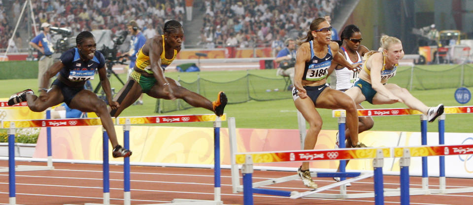 FILE - In this Aug. 19, 2008, file photo, United States' LoLo Jones center, stumbles after hitting a hurdle in the women's 100-meter hurdles during the athletics competitions in the National Stadium at the Beijing Olympics in Beijing. When Lolo Jones opens her book, “Over It,” she doesn’t start with her biggest accomplishment. Instead, she opens with the “most painful race” of her career—the 100-meter hurdles at the 2008 Beijing Olympics. (AP Photo/Vincent Thian, File)