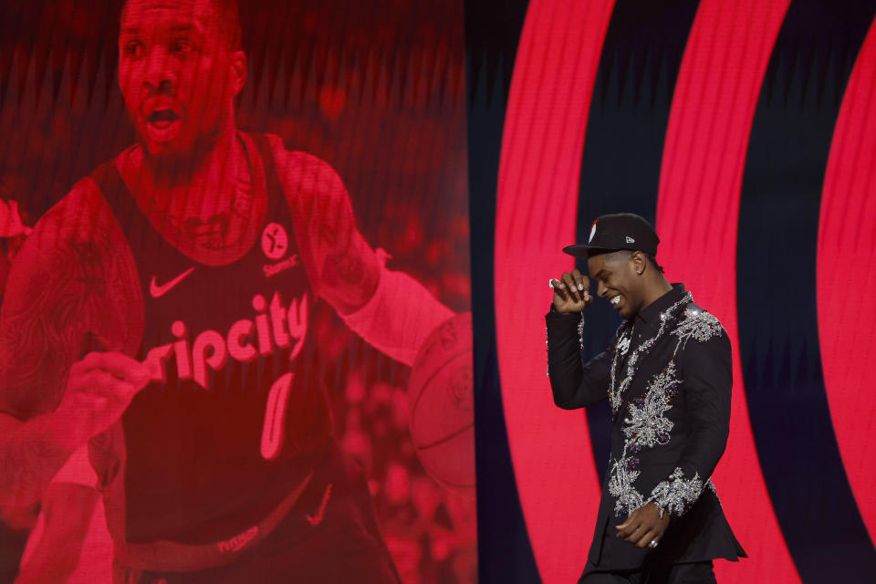 Scoot Henderson walks in front of the NBA Draft stage and a photo of Damian Lillard after being selected third overall pick by the Portland Trail Blazers on June 22, 2023. (Sarah Stier/Getty Images)