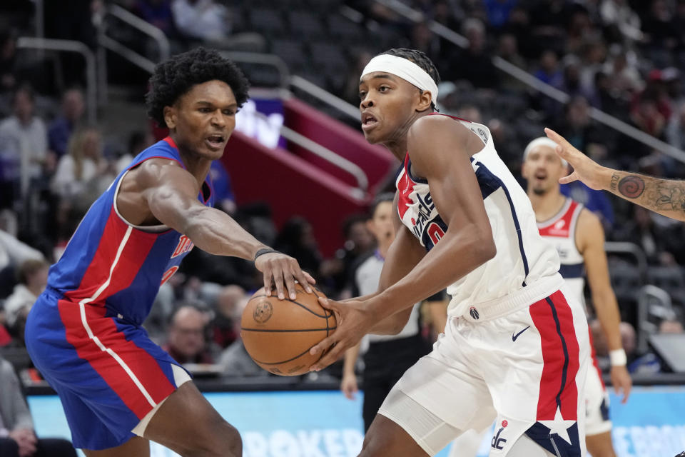 Detroit Pistons forward Ausar Thompson knocks the ball away from Washington Wizards guard Bilal Coulibaly during the first half of an NBA basketball game, Monday, Nov. 27, 2023, in Detroit. (AP Photo/Carlos Osorio)