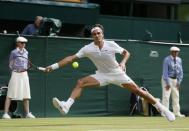 Roger Federer of Switzerland hits a shot during his match against Sam Querrey of the U.S.A. at the Wimbledon Tennis Championships in London, July 2, 2015. REUTERS/Stefan Wermuth