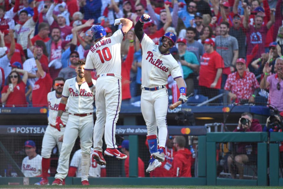 Phillies catcher J.T. Realmuto celebrates his inside the park home run in the third inning with designated hitter Bryce Harper.