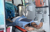 In this photo provided by Sri Lanka Navy, an injured crew member of the MT New Diamond, is carried to an ambulance Thursday, Sept. 3, 2020, in Sangamankanda, Sri Lanka. A flotilla from Sri Lanka and India was escalating efforts to douse a fire raging on the oil tanker east of Sri Lanka for a second day Friday. The fire started Thursday in an engine room boiler on the MT New Diamond, leaving one crew member injured and one missing.(Sri Lanka Navy via AP)