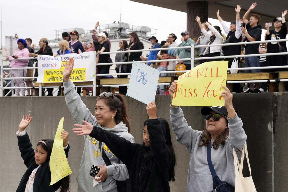 Family members and friends of the crew of the U.S. navy aircraft carriers USS Ronald Reagan (CVN-76) see off at the U.S. navy's Yokosuka base Thursday, May 16, 2024, in Yokosuka, south of Tokyo. This is the ship's final departure from Yokosuka before transiting back to the United States. (AP Photo/Eugene Hoshiko)