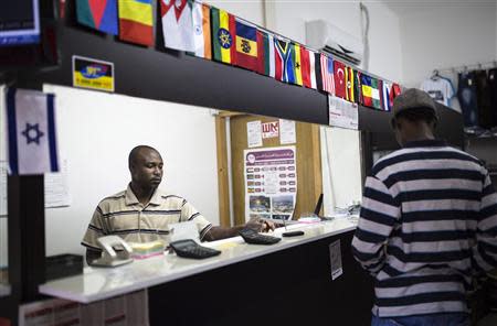 An African migrant enters a currency exchange shop in south Tel Aviv July 17, 2013. REUTERS/Amir Cohen