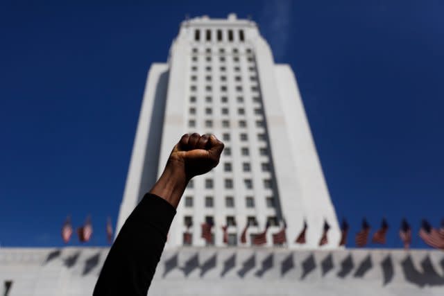 A protester holds up his fist while chanting a slogan during a protest over the death of George Floyd