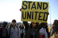 <p>Freshman Kennedi Lawson, 14, carries a sign as student walkout at Cherry Hill West High School in remembrance of those killed in the Parkland, Fla., shooting in Cherry Hill, N.J., on Wednesday, March 14, 2018. ( Photo: David Maialetti /The Philadelphia Inquirer via AP) </p>