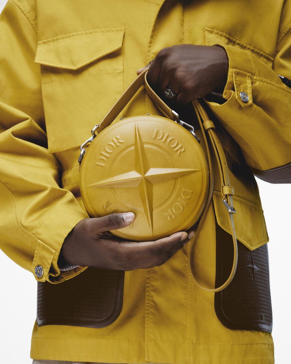 A yellow jacket and bag from Dior's capsule collection with Stone Island