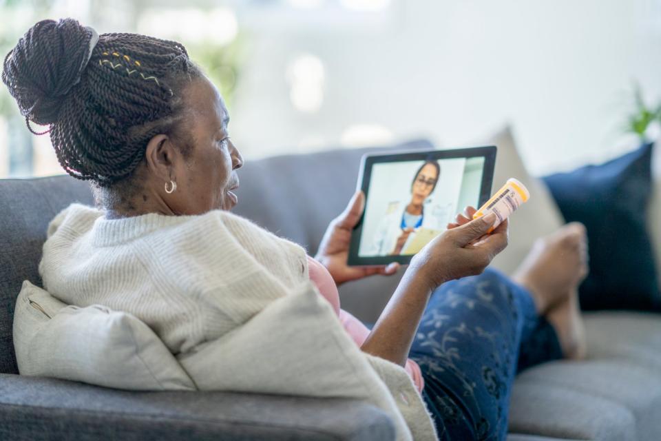 A person doing a telemedicine consultation on a tablet.