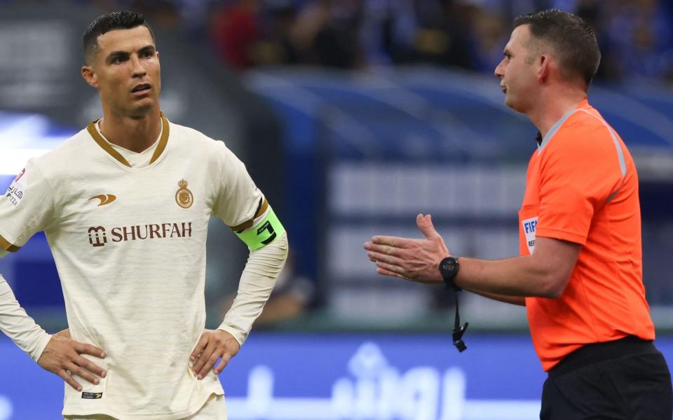 Cristiano Ronaldo of Al-Nassr listens to English referee Michael Oliver during the Saudi Pro League football match against Al-Hilal in Riyadh on April 18, 2023.
