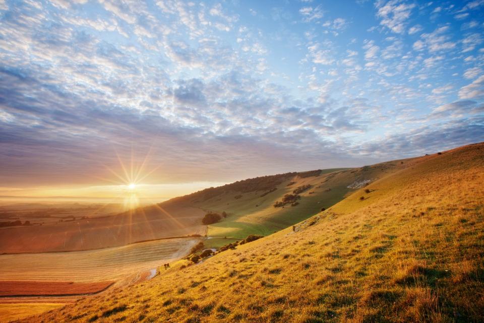 A sunrise over chalk downland viewed from Wilmington Hill in the South Downs National Park, East Sussex: Guy Edwardes/National Trust/PA Wire