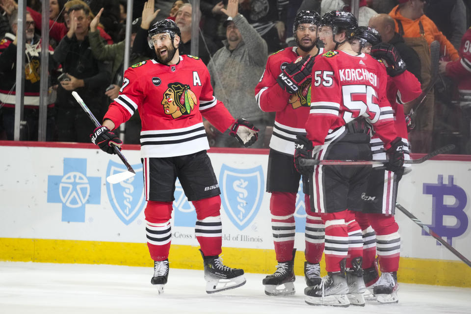 Chicago Blackhawks left wing Nick Foligno, left, celebrates his goal during the second period an NHL hockey game against the Nashville Predators, Tuesday, Dec. 5, 2023, in Chicago. (AP Photo/Erin Hooley)