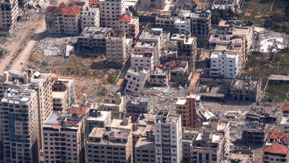 PHOTO: Destroyed buildings are seen through the window of a U.S. Air Force airplane flying over the Gaza Strip, Mar. 14, 2024.  (Leo Correa/AP)