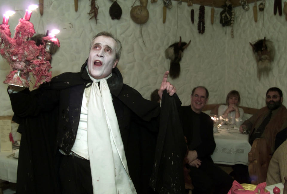 Romanian actor Petrica Moraru performs as the bloodthirsty Dracula for the guests at the Club Count Dracula restaurant in Bucharest March 2003. REUTERS/Bogdan Cristel