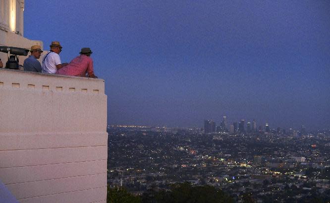 This July 12, 2016 photo shows visitors at the Griffith Observatory in Los Angeles. Fans of movies nominated for Oscars this year will be pleased to know that they can visit many real places in homage to their favorite films, from a diner in Miami where part of "Moonlight" was shot to a pier in Los Angeles used in "La La Land" and a house in Pittsburgh used in "Fences." (AP Photo/Richard Vogel)