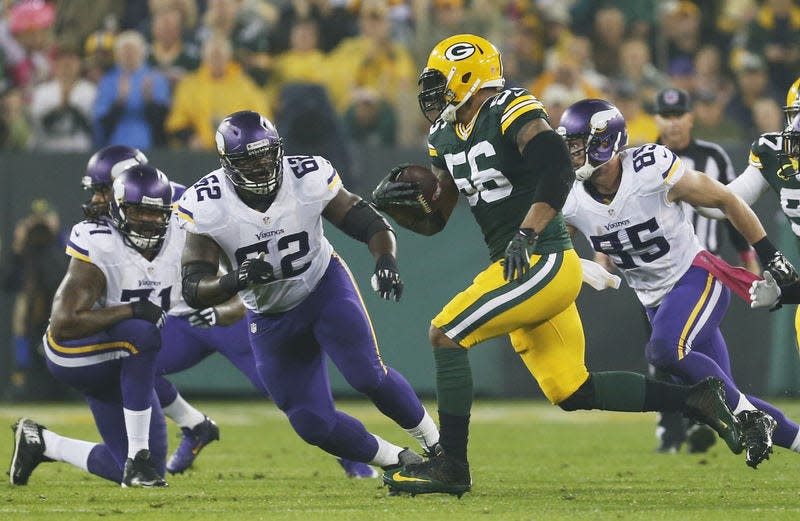 Green Bay Packers linebacker Julius Peppers runs back an interception 49 yards for a touchdown against Minnesota.