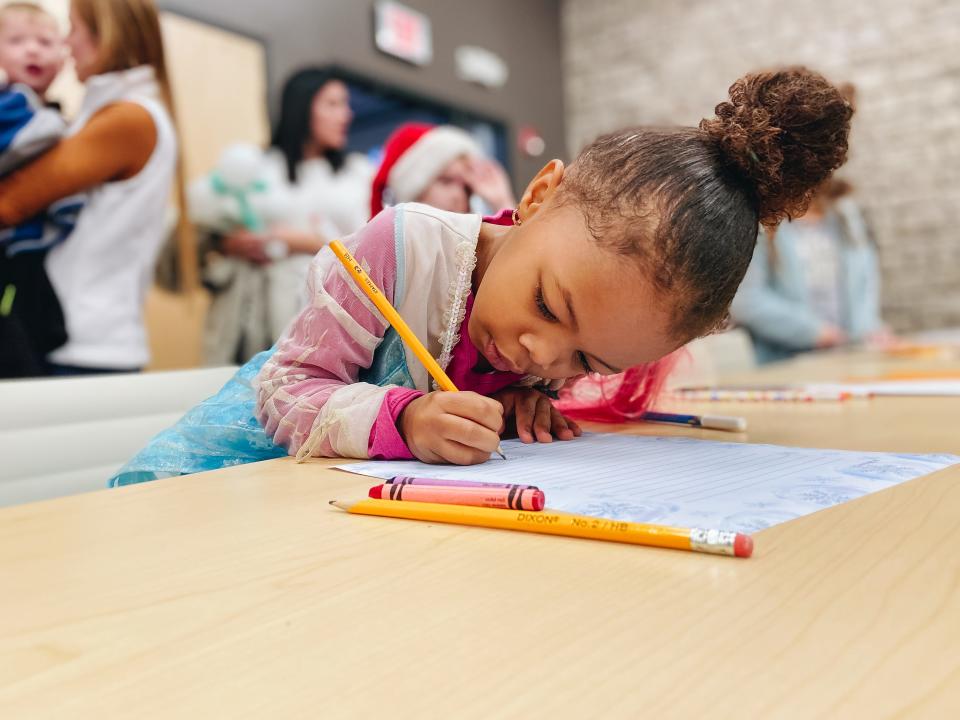 A child writes a gift wish list for Santa at the Ellettsville branch of the Monroe County Public Library during the Santa on Sale event in 2019. Meet Santa, and get a free photo and a toy at this year’s event on Saturday. Masks are required.