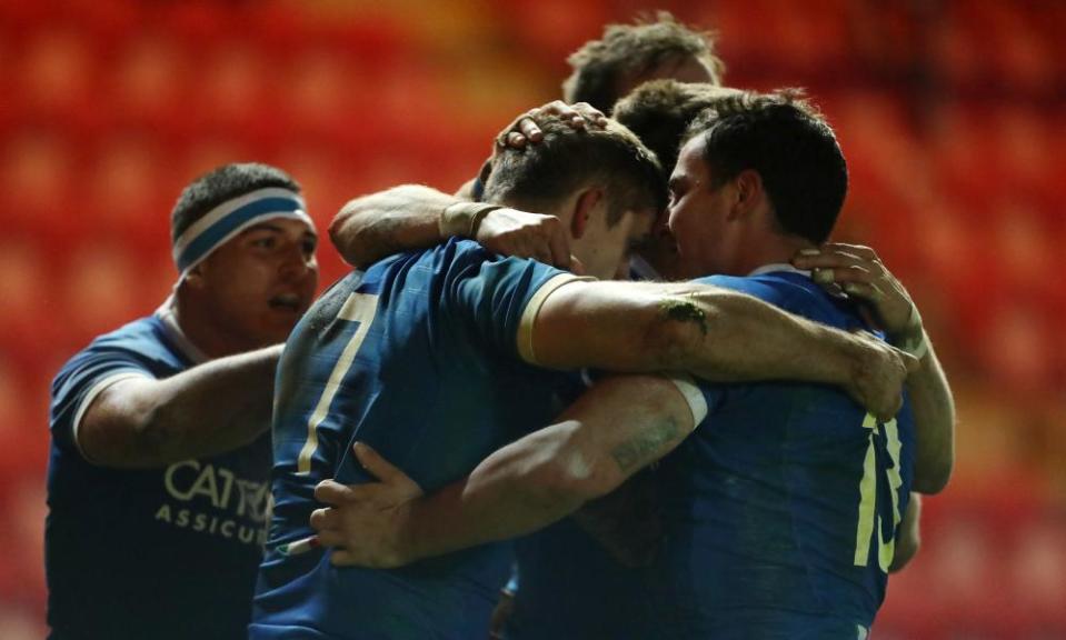 Italy’s Johan Meyer (centre) celebrates scoring a try against Wales.