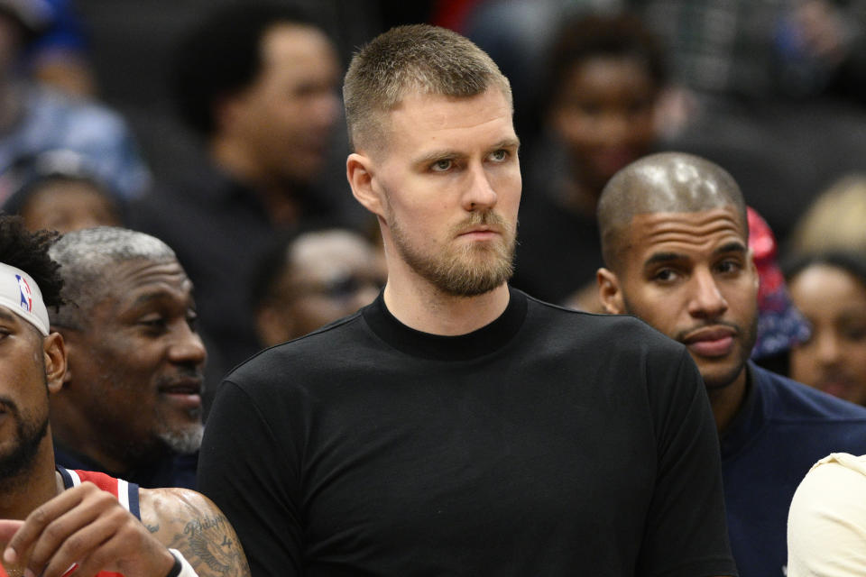 Washington Wizards center Kristaps Porzingis watches from the bench during the second half of an NBA basketball game against the Chicago Bulls, Wednesday, Jan. 11, 2023, in Washington. The Wizards won 100-97. (AP Photo/Nick Wass)