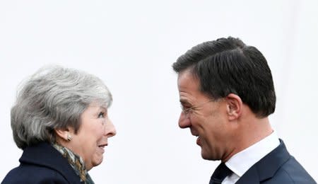 FILE PHOTO: British Prime Minister Theresa May is welcomed by Dutch Prime Minister Mark Rutte ahead of a meeting in the Hague, the Netherlands, December 11, 2018. REUTERS/Piroschka van de Wouw/File Photo