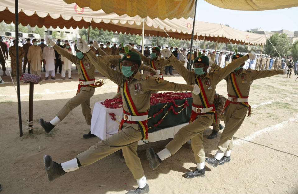 Pakistani soldiers attend the funeral of their colleague who died in the crash of a state-run Pakistan International Airlines plane on May 22, in Karachi, Pakistan, Monday, June 1, 2020. (AP Photo/Fareed Khan)