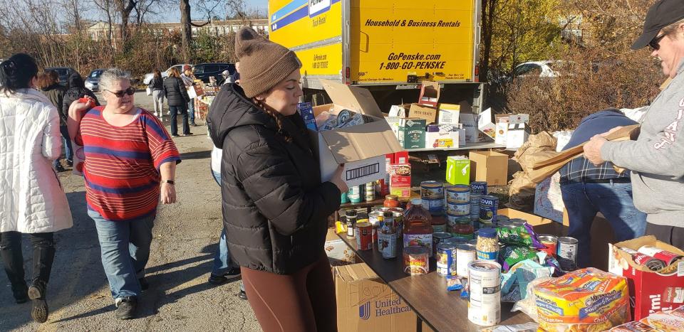 Volunteers pack roughly 750 Thanksgiving food baskets at MAG Auto Corp in the Town of Poughkeepsie Sunday.