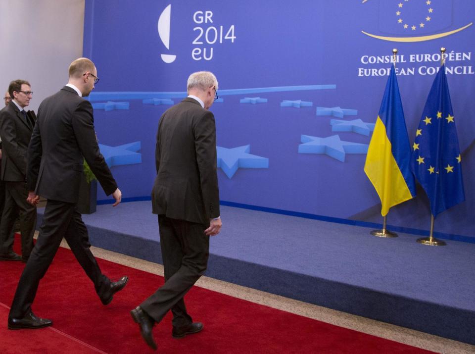 European Council President Herman Van Rompuy, right, walks with Ukrainian Prime Minister Arseniy Yatsenyuk prior to a meeting at an EU summit in Brussels on Thursday, March 6, 2014. EU heads of state meet Thursday in emergency session to discuss the situation in Ukraine. (AP Photo/Virginia Mayo)