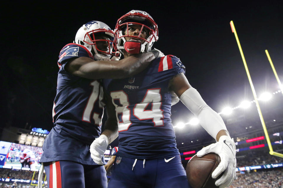 New England Patriots wide receiver Kendrick Bourne (84) is embraced by Nelson Agholor, left, after his touchdown against the Dallas Cowboys during the second half of an NFL football game against the Dallas Cowboys, Sunday, Oct. 17, 2021, in Foxborough, Mass. (AP Photo/Michael Dwyer)