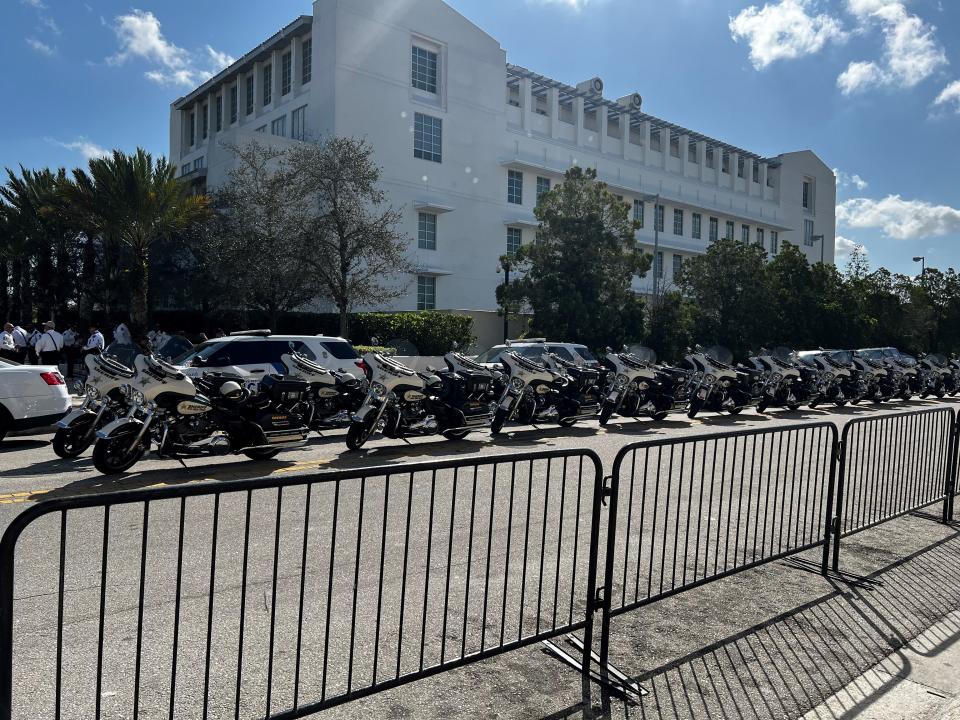 Law enforcement vehicles line up at the federal courthouse in Fort Pierce, ready to lead an exiting former President Donald Trump when he decides to leave the closed hearing in his criminal documents case. It could last until 2 p.m.