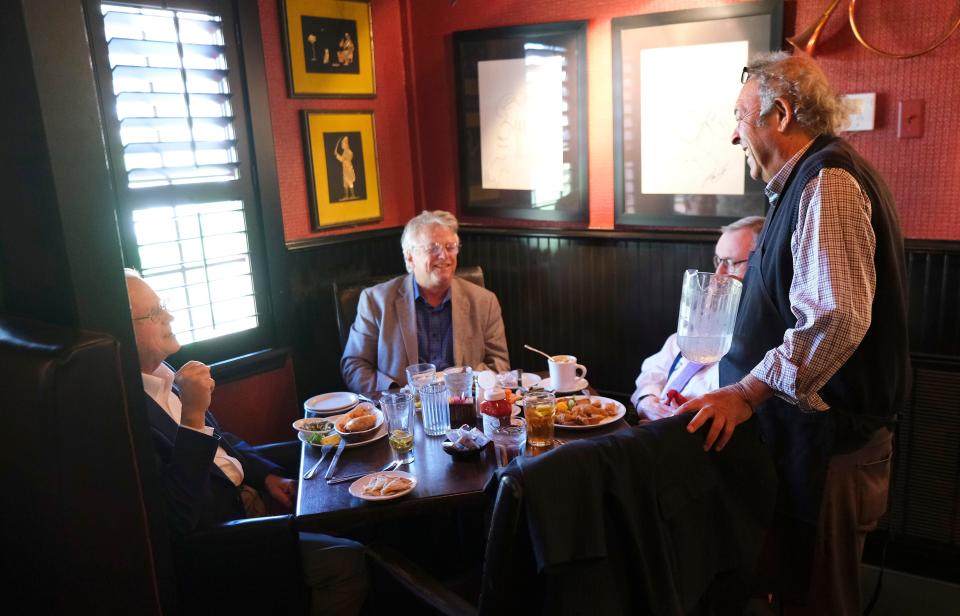 Jamil's Steakhouse owner Greg Gawey visits with, from left, Bob Blackburn, Phil Moss and Glen Johnson on April 4.