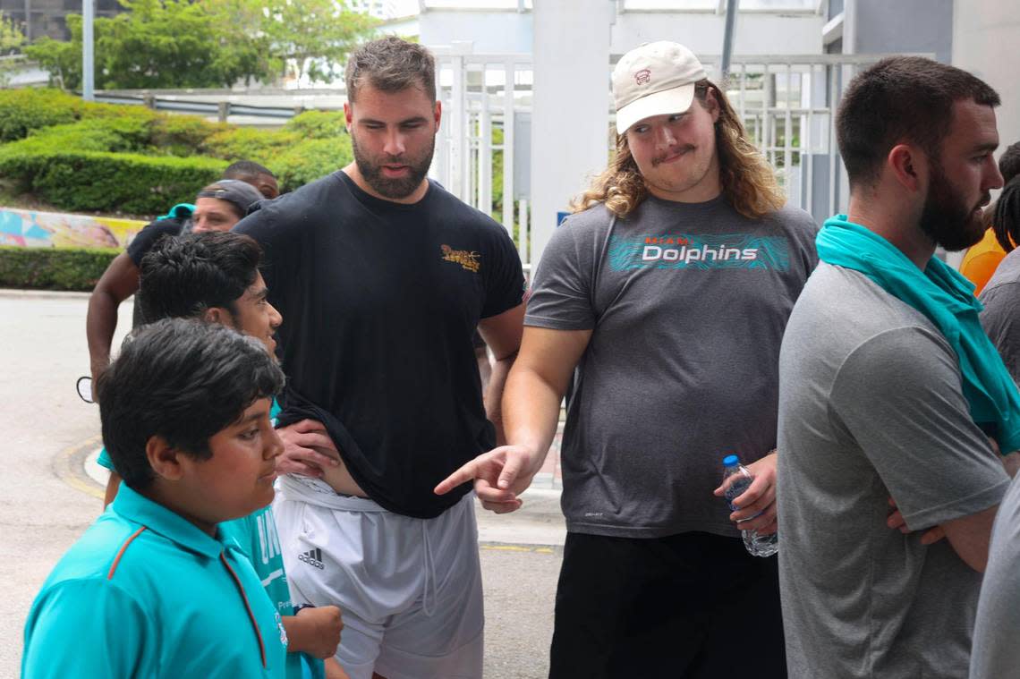 Blaise Andries, right, offensive lineman of the Miami Dolphins rookie class, and Kellen Diesch, another offensive lineman, talk with Zain Khan, 11, left bottom, and Bilan Siddiqui, 14, kids from the Islamic Center of Greater Miami, during a historic walking tour of Downtown Miami on Wednesday, June 15, 2022, beginning with tour leaders at the History Miami Museum. Andries is from Minnesota and Diesch is from Dallas.