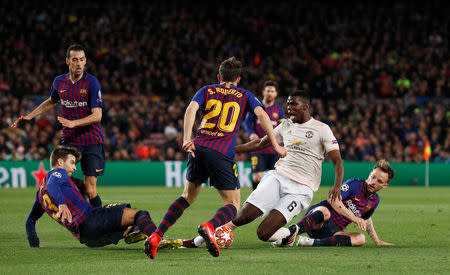 Soccer Football - Champions League Quarter Final Second Leg - FC Barcelona v Manchester United - Camp Nou, Barcelona, Spain - April 16, 2019 Manchester United's Paul Pogba in action with Barcelona's Ivan Rakitic, Sergi Roberto and Gerard Pique REUTERS/Albert Gea