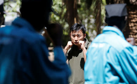 Chinese national Jack Wang, a security trainer at the Chinese-run Deway Security Group leads Kenyan security guards in martial arts combat training at their company compound in Kenya's capital Nairobi, March 13, 2017. REUTERS/Thomas Mukoya