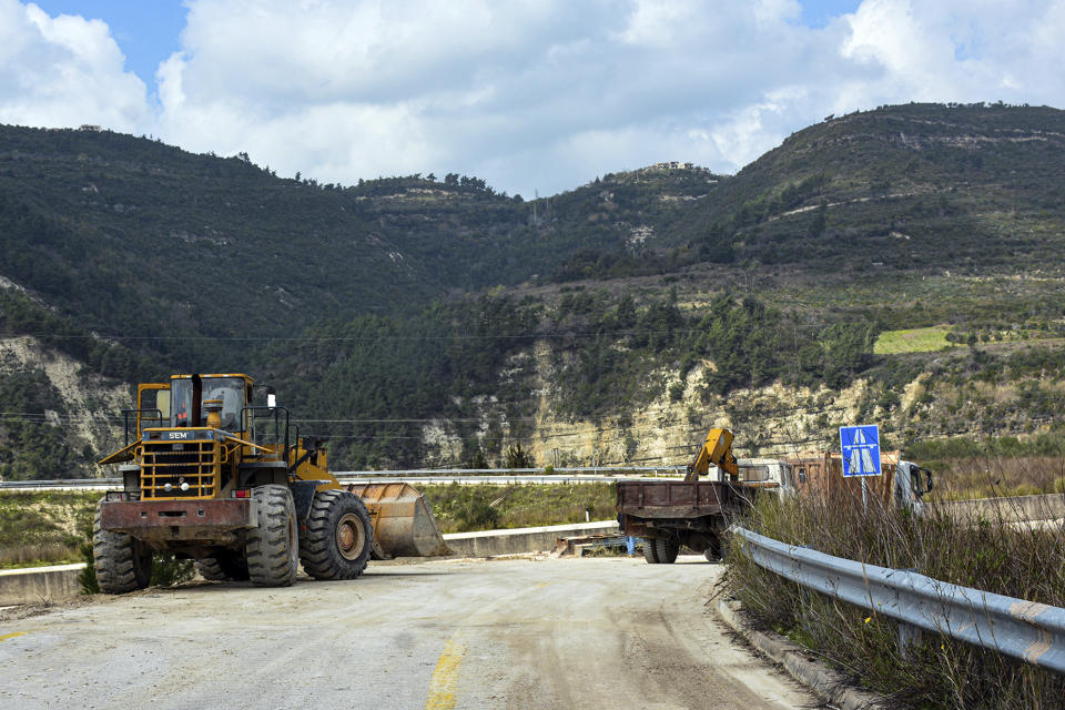 This Tuesday, March. 10, 2020 photo released by the Syrian official news agency SANA, shows workers removing barriers from the road that links Syria’s coastal region with the northern city of Aleppo, in Latakia province, Syria. The reopening of the M4 highway that has been closed since 2012 is part of a deal reached earlier this month between Turkey and Russia that stopped a Russian-backed government offensive on the northwestern province of Idlib, the last rebel stronghold in the country. (SANA via AP)